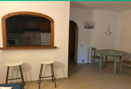a kitchen with a table and stools in a room at Son Parc Menorca recién reformado! in Son Parc