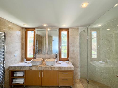 a bathroom with two sinks and a shower at Luxury Villa in Sani, Halkidiki, Greece in Sani Beach