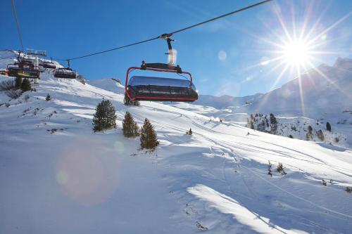 a ski lift going up a snow covered mountain at Hotel Rosanna by Alpeffect Hotels in Sankt Anton am Arlberg