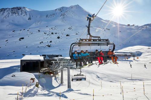 a group of people on a ski lift in the snow at Hotel Rosanna by Alpeffect Hotels in Sankt Anton am Arlberg