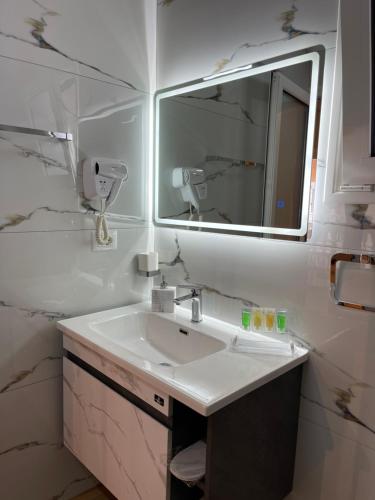 a bathroom with a sink and a mirror at Arial Penthouse Suites in Vlorë
