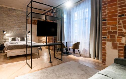 a bedroom with a bed and a tv in a room at N48 Boutique Hotel in Tallinn