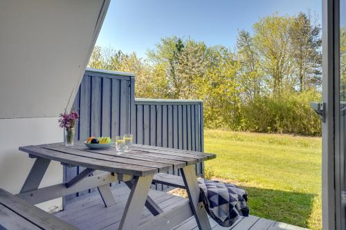 a picnic table on the back porch of a house at Lalandia Rødby in Rødby