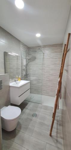 a bathroom with a toilet and a sink and a shower at ACR Holiday Apartment in Quarteira