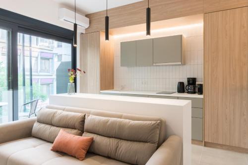a living room with a couch and a kitchen at Voda Luxury Residence #101 in Athens