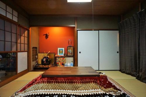 a room with a table and a rug on the floor at Villa Kyoto Saiin in Kyoto