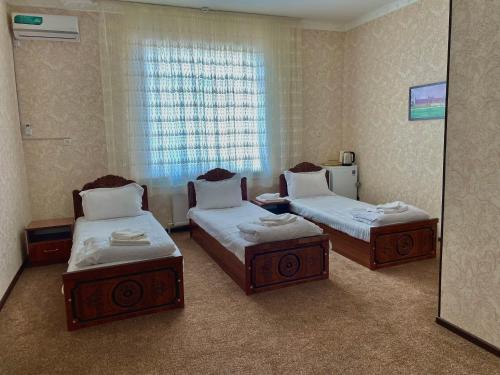 מיטה או מיטות בחדר ב-CHO'PON OTA Hotel