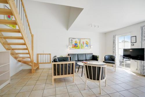 a living room with a couch and a table at Lalandia Rødby in Rødby
