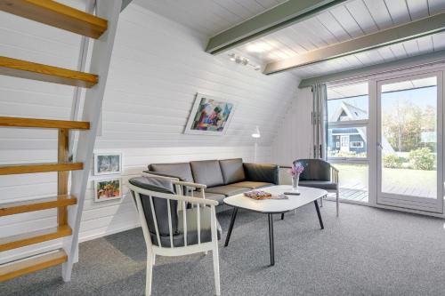 a living room with a couch and a table and chairs at Lalandia Rødby in Rødby