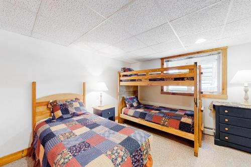 a bedroom with two beds and a bunk bed at Jay Peak Village Home 367B in Jay