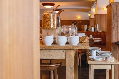 a table with bowls and other food items on it at Le Val Thorens, a Beaumier hotel in Val Thorens