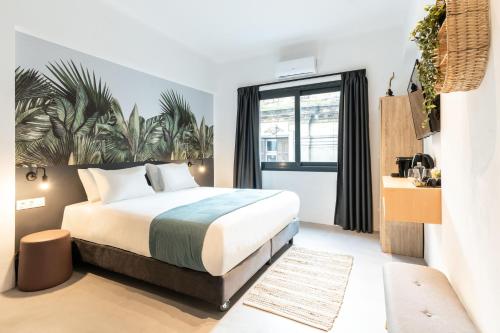 a bedroom with a bed with a plant mural on the wall at PAME Wild in Athens