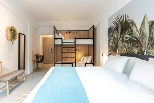 a bedroom with a large white bed and a desk at PAME Wild in Athens