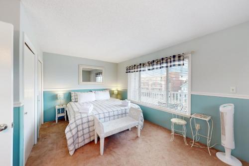 a bedroom with a bed and a window at Dewey Villas --- 24 Dickinson Ave, Unit #8B in Dewey Beach
