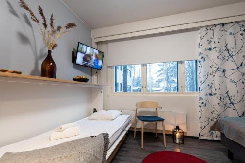 a small bedroom with a bed and a window at Hotel Linnasmäki in Turku