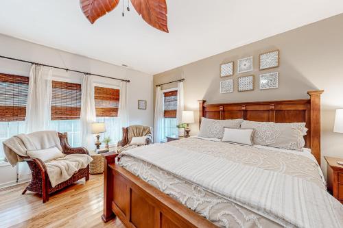 a bedroom with a large bed and two chairs at Breezewood 139 Whisperwood Ln in Rehoboth Beach