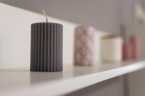 a black candle sitting on top of a counter at Newly built detached house with parking in Larisa
