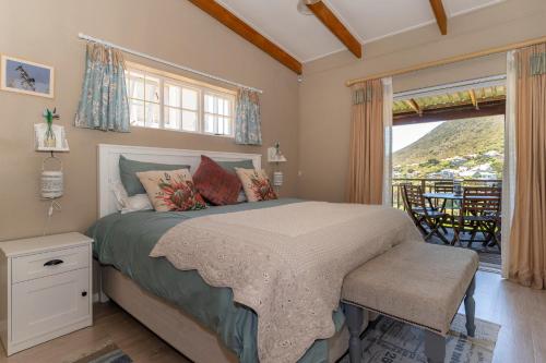 a bedroom with a bed and a large window at Tweni Cottage in Clovelly