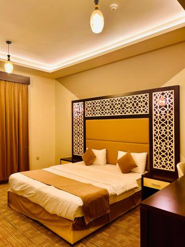a bedroom with a large bed in a room at Arabian Palm Hotel in Rabigh