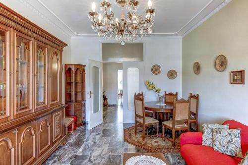 a living room with a table and a chandelier at Attico storico in Turin