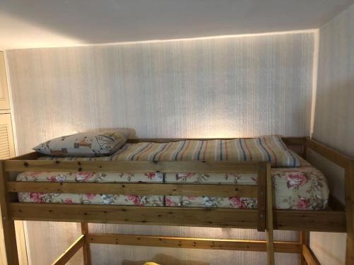 a wooden bunk bed in a small room at Appartement Paris près de Gare de Lyon in Paris