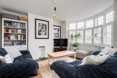 a living room with two couches and a table at Orchard - 3 Bedroom House Headington & parking & garden in Oxford