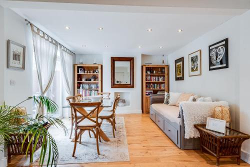 a living room with a couch and a table at Orchard - 3 Bedroom House Headington & parking & garden in Oxford