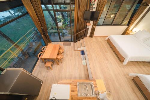 an overhead view of a bedroom with a bed and a table at Kenaray Farmstay riverside in Kaeng Krachan