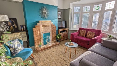 a living room with a couch and a fireplace at Durham & University On Your Doorstep (Free Parking) in Durham