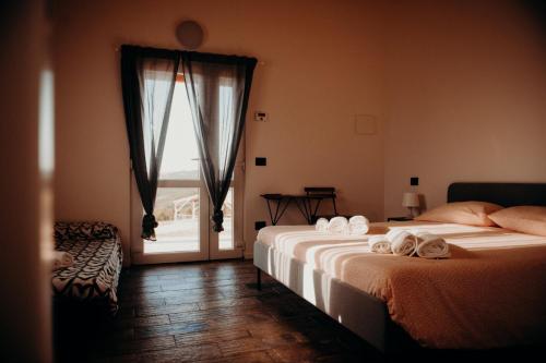 two beds in a room with a window at Azienda Agricola Saint Hubert in Cantalupo Ligure