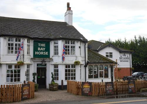 a white inn with a sign on the front of it at The Bay Horse Hotel in Haydock