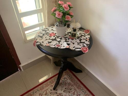 a round table with flowers on top of it at Damai Homestay in Kampong Jabi