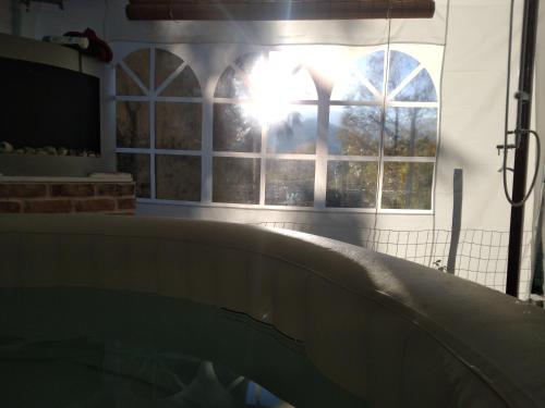 a bath tub in a room with a window at B&B LA MARMOTTA in Coazze