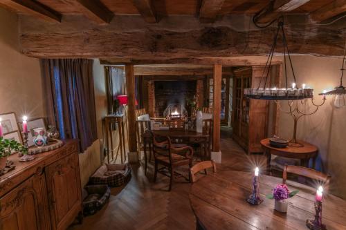 a living room with a table and a dining room at Cottage les forières in Saint-Honoré