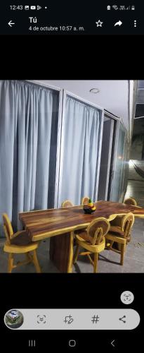a wooden table and two chairs and a table and a table and chairs at Apartment by the sea in Puerto Colombia