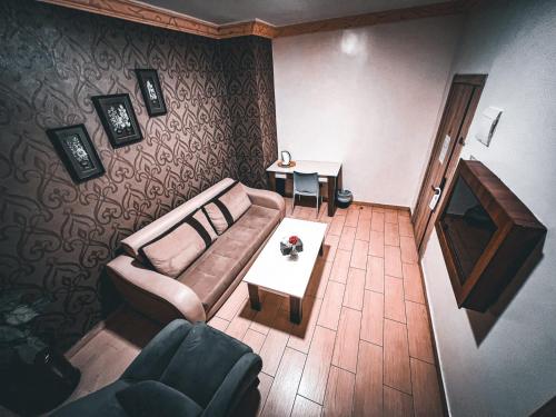 a living room with a couch and a table at Balcony Hotel in Amman