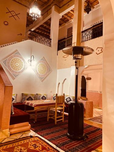 a room with a bed and a table in a room at Auberge Tissadrine in Akhendachou nʼAït Ouffi