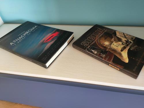 two books sitting on top of a table at Casa Il Delfino in Aci Castello
