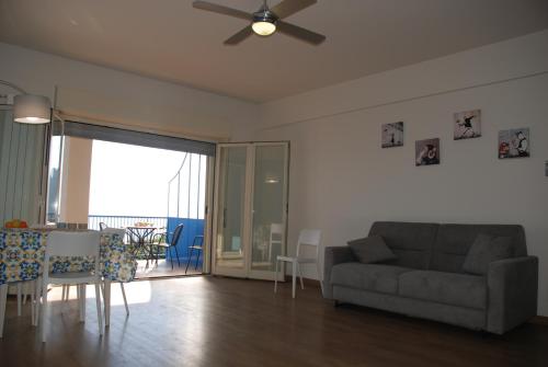 a living room with a couch and a table at Casa Il Delfino in Aci Castello