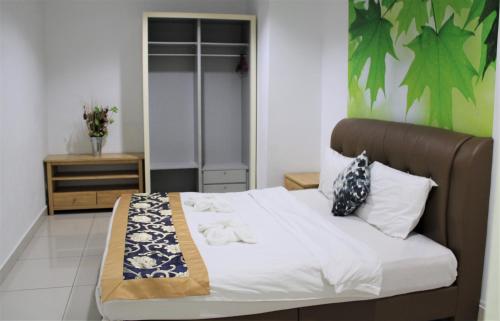 a bedroom with a large bed with a brown headboard at Mansion One SeaView Georgetown 2BR 6 Pax in George Town