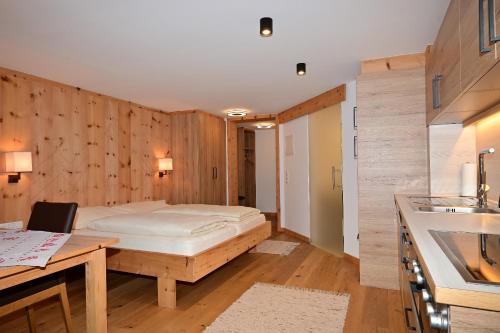 a bedroom with a bed in a wooden wall at ZIRBENNEST Haus Martha in Biberwier