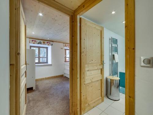 La salle de bains est pourvue d'une porte en bois. dans l'établissement L'Aigle du Laisinant duplex de 90m2 à Val d'Isere, à Le Fornet