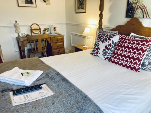 a bedroom with a bed with a remote control on it at The Bull Hotel in Horncastle