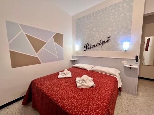 a bedroom with a bed with two towels on it at Hotel Principe in Pietra Ligure
