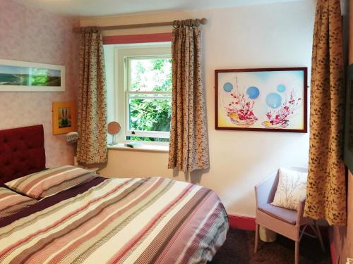 a bedroom with a bed and a window at T Melindwr in Capel Bangor