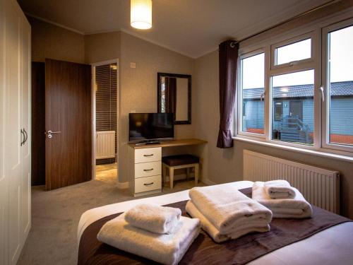 a bedroom with a bed with towels on it at Beech - Ukc4530 in Darsham