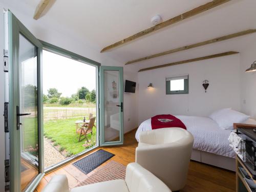 a bedroom with a bed and a sliding glass door at Rosemary in Wootton Bridge