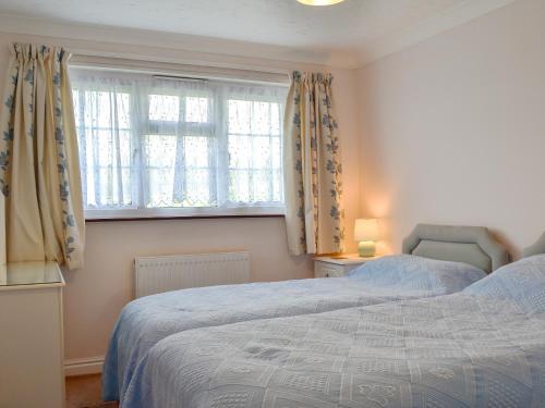 a bedroom with two beds and a window at The Annexe in Newchurch