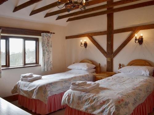 a bedroom with two beds and a window at Ashley's in Colyton