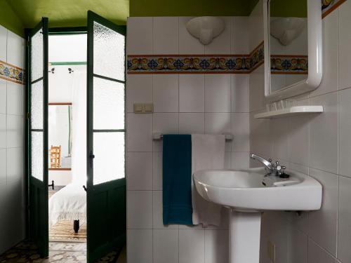 a bathroom with a sink and a mirror at Mesón La Hospedería in Cómpeta